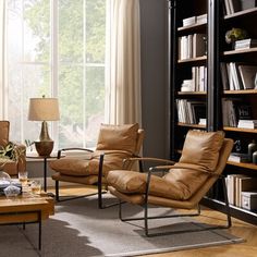 a living room filled with furniture and bookshelves next to a large open window