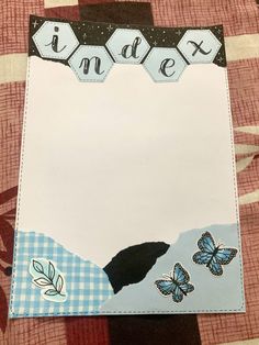 a close up of a piece of paper with butterflies on it and the words index