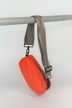 Our best seller — now in orange! Nylon material with an adjustable web and leather strap to allow you to wear this 3 ways-around your waist, shoulder or as a crossbody. Fun voluminous shape makes this bag unique and sporty too! Go hands free for your life on the go.   Inside slip pocketStrap fits most waists   Content: Sporty Outdoor Crossbody Chest Bag, Sporty Crossbody Chest Bag For Outdoor, Versatile Crossbody Chest Bag For Outdoor Activities, Functional Bags With Detachable Strap For Outdoor Activities, Sporty Crossbody Shoulder Bag For Outdoor Activities, Sporty Shoulder Bag With Adjustable Strap, Sporty Everyday Belt Bag, Sporty Crossbody Shoulder Bag With Zipper Pocket, Sporty Crossbody Chest Bag With Adjustable Strap