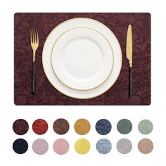 a place setting with silverware, plates and napkins on a burgundy tablecloth