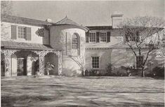 an old photo of a large house with lots of windows