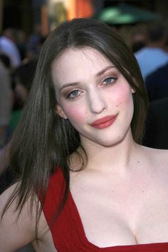 a woman in a red dress posing for the camera