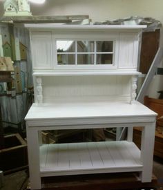 a white shelf sitting on top of a hard wood floor