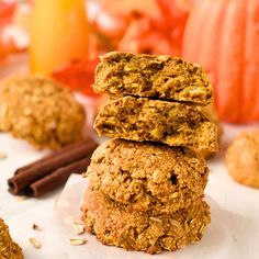 three cookies stacked on top of each other next to cinnamon sticks and pumpkins in the background