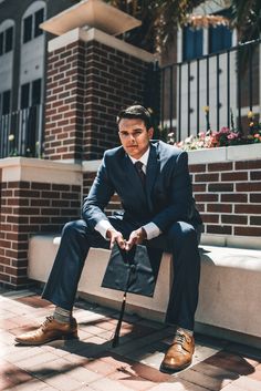 a man in a suit and tie sitting on a bench