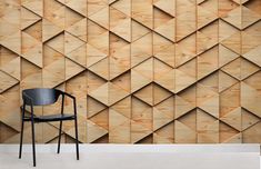 a chair sitting in front of a wall with wooden panels on it's sides