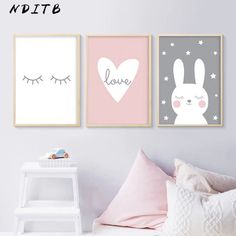 three posters on the wall in a bedroom with pink and grey colors, one has an animal