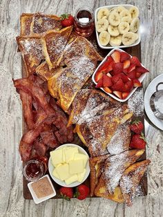 the breakfast platter includes french toast, strawberries, bananas, and other fruit