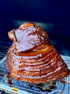 a large piece of meat sitting on top of a grill