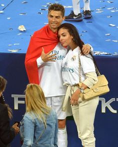 a man and woman standing next to each other on a tennis court