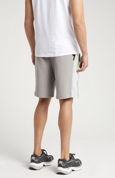 PUMA and LA-based label PLEASURES collaborate on these comfy cotton French terry sweat shorts done in a cool colorblock style with neon trim. 8" inseam; 25" leg opening; 13" front rise; 16 1/2" back rise (size Medium) Elastic/drawstring waist Front welt pockets 70% cotton, 30% recycled cotton Machine wash, tumble dry Imported PUMA has received the Fair Labor Association accreditation, which signifies that the company has effective systems and procedures in place to successfully uphold fair labor standards throughout its supply chains, including strategies and tools to address and improve working conditions Gray Cotton Summer Activewear, Gray Cotton Athletic Shorts For Loungewear, Sporty Gray Cotton Shorts, Gray Cotton Athleisure Shorts, Gray Cotton Sportswear Shorts, Gray Relaxed Fit Sporty Shorts, Gray Cotton Activewear With Built-in Shorts, Gray Cotton Athletic Shorts, Sporty Cotton Shorts For Leisure