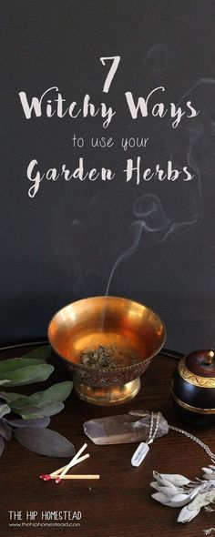 a wooden table topped with metal bowls filled with plants and incense sticks on top of it