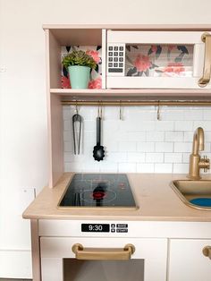 a kitchen with a stove top oven sitting under a microwave next to a sink and cupboards