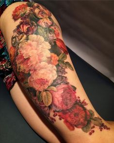 a woman's arm with flowers on it