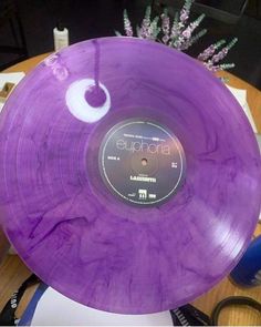 a purple frisbee sitting on top of a wooden table