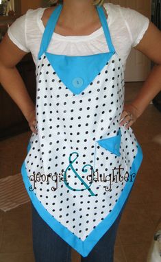 a woman wearing an apron with polka dots on it