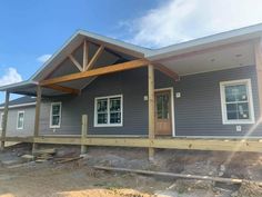 a house under construction with the front porch covered in wood and siding on top of it