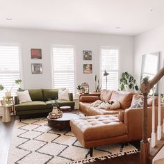 a living room filled with furniture and lots of windows