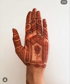 a hand with henna tattoos on it