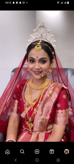 a woman wearing a red and gold bridal outfit