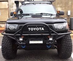 a black toyota truck parked in a parking lot