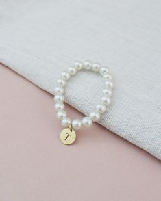 All time classic pearls bracelet with added initial to complete your look. Choose from silver, rose gold, or gold initials to match with your personality and give a modern touch on a traditional style.Great for bride or for birthday gifts, flower girls, brides or or bridesmaids to wear on the wedding day. ** Please put the preferred letter initial on notes upon checkout ** This listing is only for 1 bracelet. Bracelet is measured to approximately 7 - 8 inches, however, it can stretch to match wr Elegant White Name Bracelet For Mother's Day, Elegant Hypoallergenic Name Bracelet With Round Beads, Elegant White Name Bracelet With Letter Beads, Classic White Name Bracelet As Gift, Elegant White Name Bracelet For Bridesmaid Gift, Elegant White Name Bracelet For Gift, Elegant Hypoallergenic Name Bracelet As Personalized Gift, Elegant Beaded Bracelets With Letter Beads For Mother's Day, Elegant Mother's Day Beaded Bracelets With Letter Beads