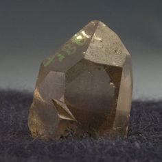 a golden diamond sitting on top of a carpet