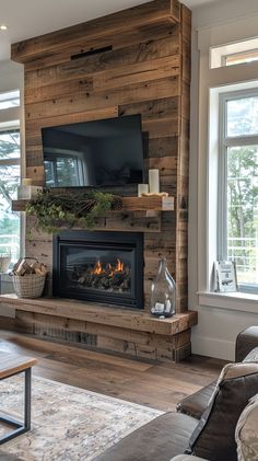 a living room filled with furniture and a flat screen tv mounted on a wall above a fire place