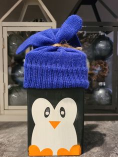 a penguin box with a blue hat on top