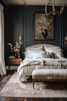 a large bed sitting in a bedroom next to a painting on the wall above it