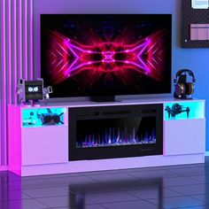 an entertainment center with a large television on it's side and colorful lights in the background