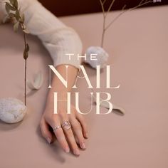 a woman's hand on top of a table next to a plant