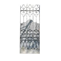 an iron gate with circular designs on the top and bottom, in front of a white background