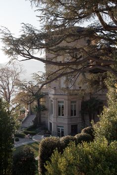 a large house with many trees around it