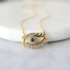 "Beautiful and lovely dainty eye pendant necklace. Made of blue stone evil eye pendant with skinny gold plated chain. Simple and warm. Necklace will ship in a gift box. If you have any question, please feel free to contact me. Thanks :) ♥ Necklace length 14\"-20\" ♥ Pendant 5/8\" x 5/8\" ♥ Gold plated over brass / Cubic Zirconia ♥ Delivery Time Fast shipping within 1 - 3 days ♥ See more Rudiana Accessories Rudiana.etsy.com" Gold Plated Necklaces With Diamond Details For Gift, Eye Pendant, Dainty Evil Eye Charm Necklace Gift, Dainty Evil Eye Necklace For Gift, Dainty Eye-shaped Jewelry For Gift, Dainty Evil Eye Necklace Gift, Dainty Eye-shaped Jewelry Gift, Elegant Gold Evil Eye Necklaces, Elegant Evil Eye Round Necklace