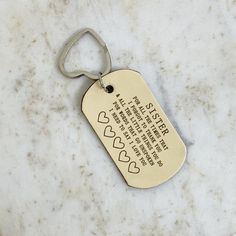 a dog tag on a marble surface with the words in english and chinese written below it