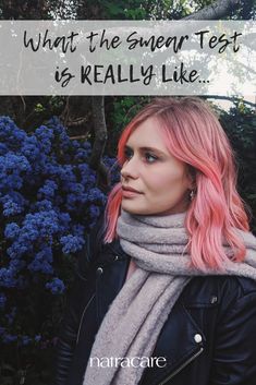 a woman with pink hair wearing a scarf