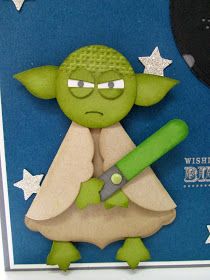 a star wars yoda holding a green object