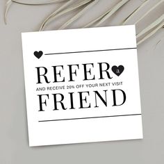 a white greeting card with the words refer and receive 20 % off your next visit