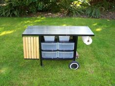 a table with several bins on it in the grass