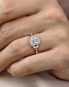 a woman's hand with a diamond ring on it