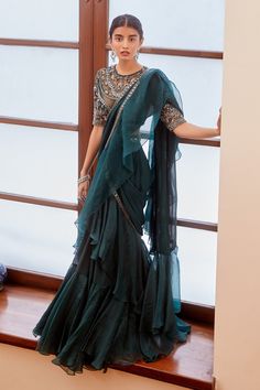 Teal green pre-draped saree with embroidered border and ruffle detailing. Comes with sheer neckline blouse.
Component: 2
Embroidered
Neckline: Round
Sleeve Length: Elbow
Fabric: Georgette
Color: Green
Mirror, resham, cutdana and sequin embroidery
Embroidered blouse
Sheer neckline and back - Aza Fashions Saree With Ruffles, Organza Drape Saree, Fashion Sarees Style, Green Ruffle Saree, Modern Traditional Dresses, Modern Indian Outfits, Mirror Work Border, Ruffled Saree, Indian Bridesmaids