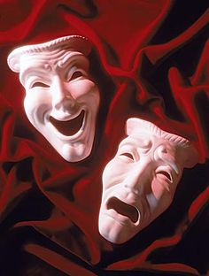 two white masks with mouths open on a red cloth covered ground, one is smiling and the other has his mouth wide open