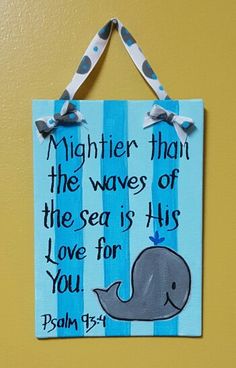 a blue and white sign hanging on the wall with a ribbon around it that says, mightier than the waves of the sea is his love for you