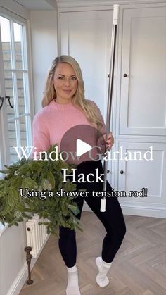 a woman is holding a pole in her hands and posing for the camera with text that reads, window garland hack using a shower tension rod