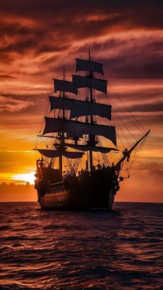 a ship sailing in the ocean at sunset