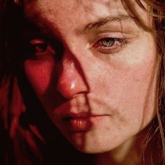 a close up of a woman's face with frecky hair