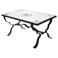 a glass and metal coffee table with an animal motif on the top, sitting on a white background