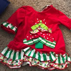 Like New, Washed But Never Worn, No Flaws, Smoke-Fee Home Long-Sleeved Christmas Top With Funky Mixed Prints, Ruffles, And Textured Christmas Tree Design Size 18 Months Playful Long Sleeve Holiday Tops, Green Ruffled Winter Tops, Winter Green Ruffled Tops, Green Ruffled Tops For Winter, Playful Red Christmas Tops, Playful Cotton Holiday Tops, Playful Cotton Tops For The Holiday Season, Cute Long Sleeve Tops For Festive Occasions, Cute Red Holiday Tops