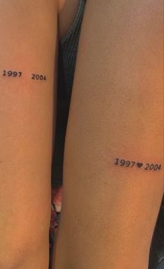 two women with matching tattoos on their legs, both showing the same time and date